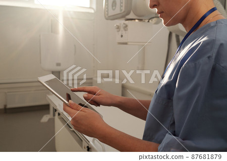 Hands of young female clinician searching for online questions of patients Hands of young female clinician searching for online questions of patients 87681879