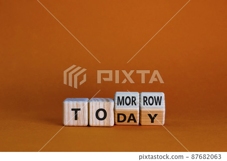 Do it today not tomorrow. Turned wooden cubes and changed the word 'tomorrow' to 'today'. Beautiful orange background, copy space. Business and tomorrow or today concept. Do it today not tomorrow. Turned wooden cubes and changed the word 'tomorrow' to 'today'. Beautiful orange background, copy space. Business and tomorrow or today concept. 87682063