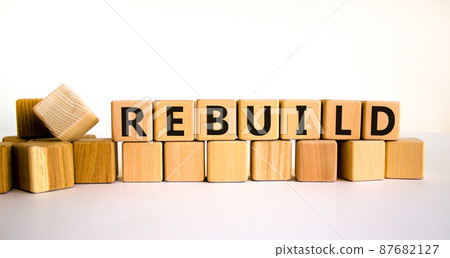Rebuild and build symbol. The concept word Rebuild on wooden cubes. Beautiful white table, white background, copy space. Business rebuild and build concept. Rebuild and build symbol. The concept word Rebuild on wooden cubes. Beautiful white table, white background, copy space. Business rebuild and build concept. 87682127