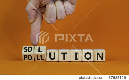 The solution to pollution symbol. Male hand flips wooden cubes and changes the word 'pollution' to 'solution'. Beautiful orange background, copy space. Business, ecological and pollution concept. The solution to pollution symbol. Male hand flips wooden cubes and changes the word 'pollution' to 'solution'. Beautiful orange background, copy space. Business, ecological and pollution concept. 87682136
