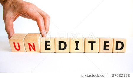 Edited or unedited symbol. Businessman turns wooden cubes and changes the word unedited to edited. Business and edited or unedited concept. Beautiful white background, copy space. 87682138