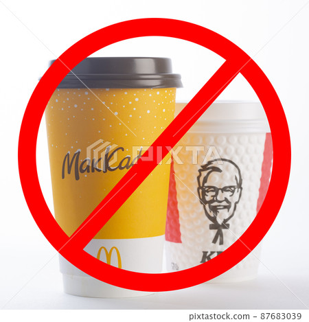 St. Petersburg, Russia - March 13, 2022: Paper cup from McDonald's and KFC crossed out on a white background. McDonald's and KFC is leaving Russia. The inscription on the cup McCafe. isolated 87683039