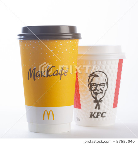 St. Petersburg, Russia - March 13, 2022: Paper cup from McDonald's and KFC out on a white background. McDonald's and KFC is leaving Russia. The inscription on the cup McCafe. isolated 87683040