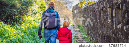 BANNER, LONG FORMAT Dad and son travelers in Montenegro in Kotor Old Town Ladder of Kotor Fortress Hiking Trail. Aerial drone view 87683714