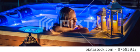 BANNER, LONG FORMAT Portrait of young carefree happy smiling woman relaxing at hot tub at night during enjoying happy traveling moment vacation. Life against the background of green big mountains BANNER, LONG FORMAT Portrait of young carefree happy smiling woman relaxing at hot tub at night during enjoying happy traveling moment vacation. Life against the background of green big mountains 87683912