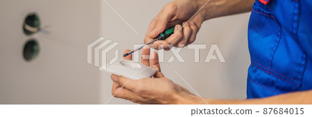 Master electrician installs a socket in the house BANNER, LONG FORMAT Master electrician installs a socket in the house BANNER, LONG FORMAT 87684015