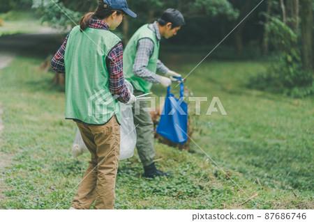 Volunteer picking up trash 87686746