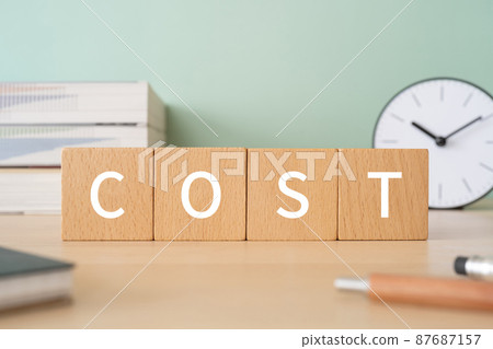 Blocks, books, clocks, notebooks, pens with the words "COST" 87687157