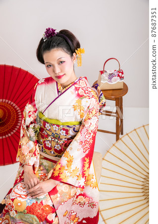 A woman wearing furisode looking at the camera Japan 87687351