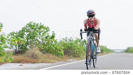 Asian young woman ride bicycle Asian young woman ride bicycle 87687884