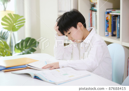 Tired child with boring study and a lot of piled up school homework 87688415