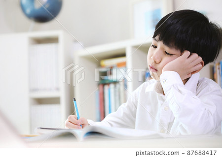 Tired student tired of tedious study and a lot of piled up school homework Tired student tired of tedious study and a lot of piled up school homework 87688417