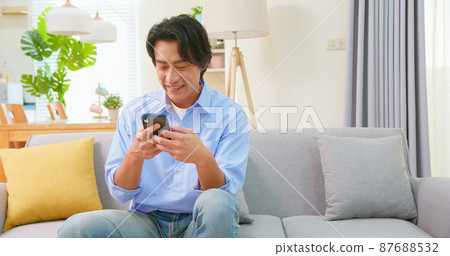 asian man use smart phone asian man use smart phone 87688532