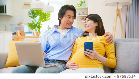 asian pregnant couple use computer asian pregnant couple use computer 87688534