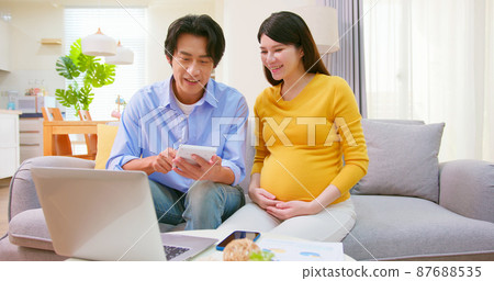 asian pregnant couple use computer asian pregnant couple use computer 87688535