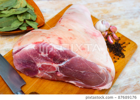 Raw pork leg with herbs and condiments ready for cooking Raw pork leg with herbs and condiments ready for cooking 87689176