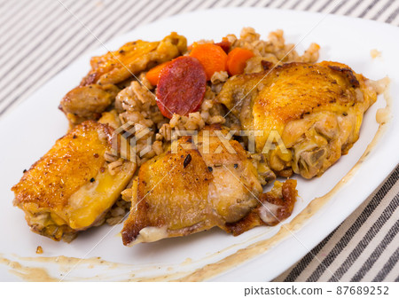 Baked chicken thighs with barley porridge Baked chicken thighs with barley porridge 87689252