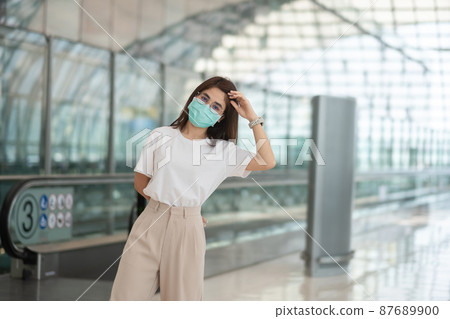 Young female wearing face mask protection Coronavirus disease infection, happy Asian woman traveler. Time to travel after vaccine booster dose concept Young female wearing face mask protection Coronavirus disease infection, happy Asian woman traveler. Time to travel after vaccine booster dose concept 87689900
