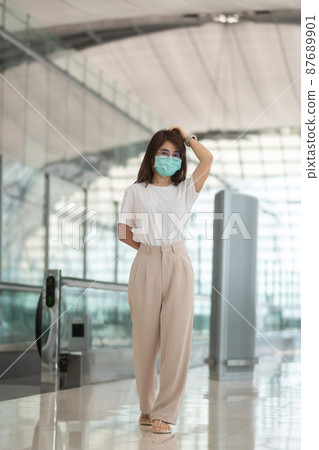 Young female wearing face mask protection Coronavirus disease infection, happy Asian woman traveler. Time to travel after vaccine booster dose concept Young female wearing face mask protection Coronavirus disease infection, happy Asian woman traveler. Time to travel after vaccine booster dose concept 87689901