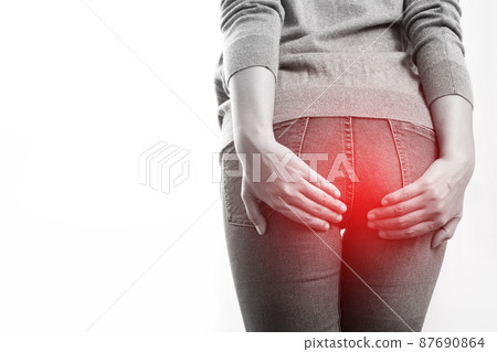 concept of health problems woman has hemorrhoids 87690864