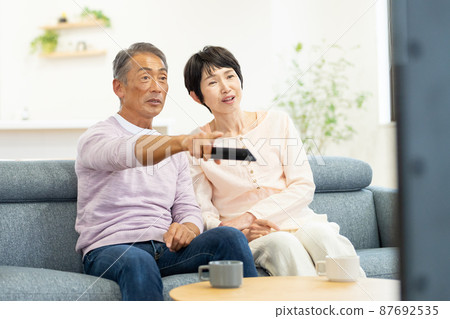 Senior couple TV living Senior couple TV living 87692535