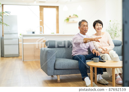 Senior couple TV living Senior couple TV living 87692539