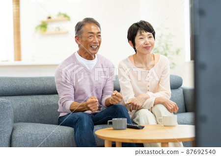Senior couple TV living Senior couple TV living 87692540