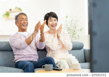 Senior couple TV living Senior couple TV living 87692541