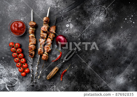 Grilled kebab, on black dark stone table background, top view flat lay, with copy space for text Grilled kebab, on black dark stone table background, top view flat lay, with copy space for text 87692835