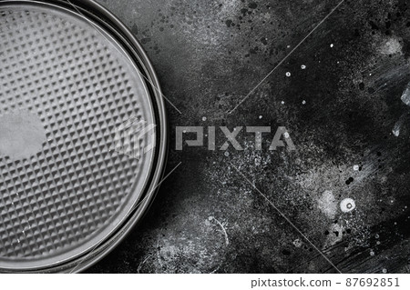 Metal empty Baking tray, with copy space for text or food, with copy space for text or food, top view flat lay , on black dark stone table background 87692851