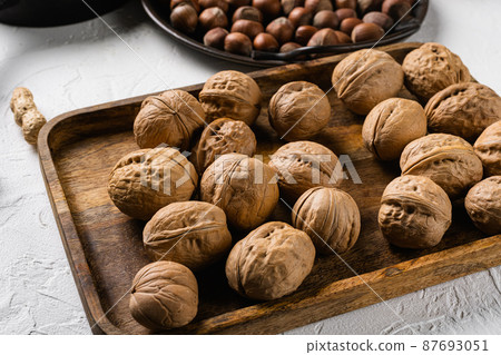 Walnut whole nut, on white stone table background Walnut whole nut, on white stone table background 87693051