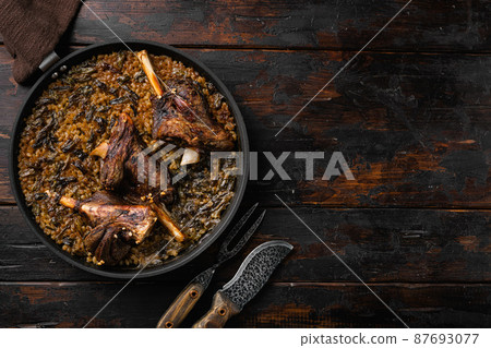 Baked whole lamb shanks meat, on old dark wooden table background, top view flat lay, with copy space for text Baked whole lamb shanks meat, on old dark wooden table background, top view flat lay, with copy space for text 87693077