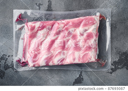 Pork ribs in a vacuum bag, on gray stone background, top view flat lay Pork ribs in a vacuum bag, on gray stone background, top view flat lay 87693087