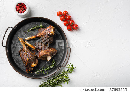 Slow roasted lamb dish meat, on white stone table background, top view flat lay, with copy space for text Slow roasted lamb dish meat, on white stone table background, top view flat lay, with copy space for text 87693335