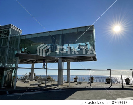 Glass-enclosed cafe / coffee shop with a view of the sea Glass-enclosed cafe / coffee shop with a view of the sea 87694323