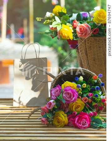 Beautiful bouquet roses flower artificial in vintage wicker basket. Artificial multicolor flowers made from cloth or fabric look like real flower. Retro style.Valentines Day concept. Selective focus. Beautiful bouquet roses flower artificial in vintage wicker basket. Artificial multicolor flowers made from cloth or fabric look like real flower. Retro style.Valentines Day concept. Selective focus. 87694747