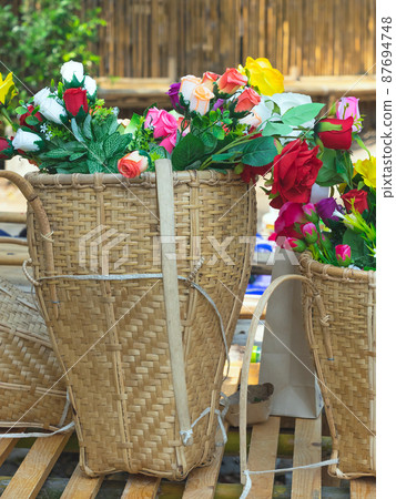 Beautiful bouquet roses flower artificial in vintage wicker basket. Artificial multicolor flowers made from cloth or fabric look like real flower. Retro style.Valentines Day concept. Selective focus. 87694748
