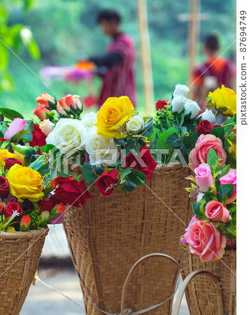 Beautiful bouquet roses flower artificial in vintage wicker basket. Artificial multicolor flowers made from cloth or fabric look like real flower. Retro style.Valentines Day concept. Selective focus. Beautiful bouquet roses flower artificial in vintage wicker basket. Artificial multicolor flowers made from cloth or fabric look like real flower. Retro style.Valentines Day concept. Selective focus. 87694749