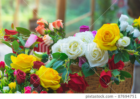 Beautiful bouquet roses flower artificial in vintage wicker basket. Artificial multicolor flowers made from cloth or fabric look like real flower. Retro style.Valentines Day concept. Selective focus. Beautiful bouquet roses flower artificial in vintage wicker basket. Artificial multicolor flowers made from cloth or fabric look like real flower. Retro style.Valentines Day concept. Selective focus. 87694751