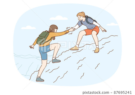 Girl help friend climbing mountain together Girl help friend climbing mountain together 87695241