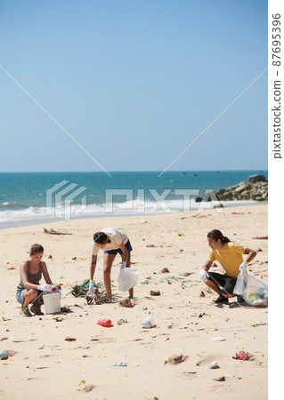 Volunteers Picking Up Plastic Trash Volunteers Picking Up Plastic Trash 87695396