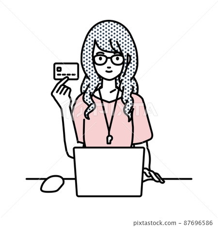 A teacher woman sitting at a desk and using a PC while holding a credit card A teacher woman sitting at a desk and using a PC while holding a credit card 87696586