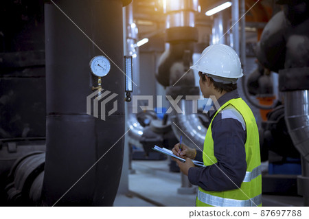 Engineer checking and inspecting at MDB panel .he working with electric switchboard to check range of voltage working in Main Distribution Boards factory. 87697788