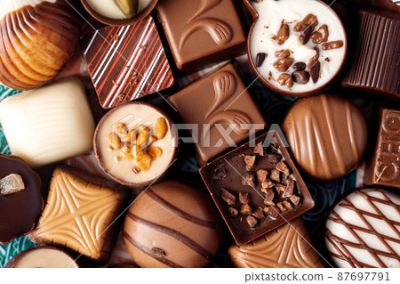 Various chocolate praline candies assortment close up 87697791