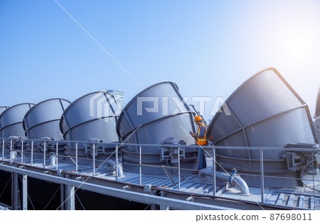 Industry engineer under checking the industry cooling tower air conditioner is water cooling tower air chiller HVAC of large industrial building to control air system. Industry engineer under checking the industry cooling tower air conditioner is water cooling tower air chiller HVAC of large industrial building to control air system. 87698011