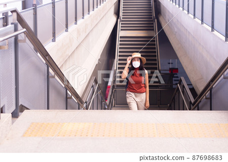 Woman passenger walking on staircase at train station,Transport insurance concept 87698683