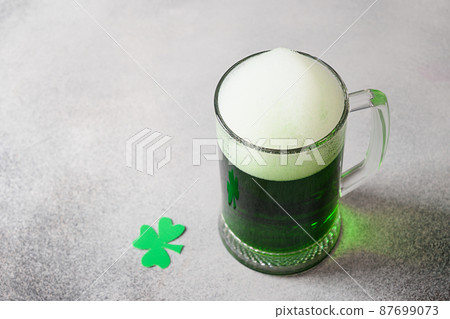 Patrick's day green beer in glass on black. Patrick's day green beer in glass on black. 87699073