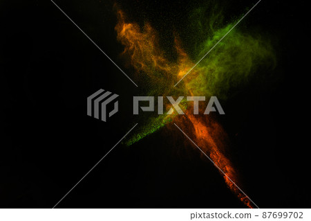 Freeze motion of colorful dust explosion on black background for Happy Holi 87699702