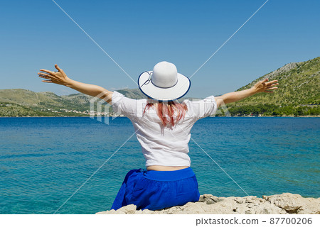 happy beautiful young woman enjoying freedom and the sea view, summer vacation happy beautiful young woman enjoying freedom and the sea view, summer vacation 87700206
