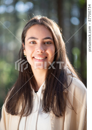 Portrait of lovely young woman in forest Portrait of lovely young woman in forest 87700734